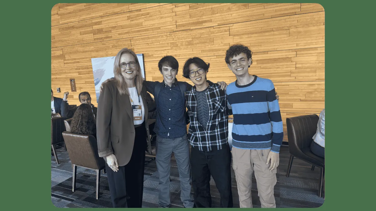Gabriel, Darien Yang and Yousef Soliman stand with British Columbia Finance Minister Brenda Bailey at Web Summit.