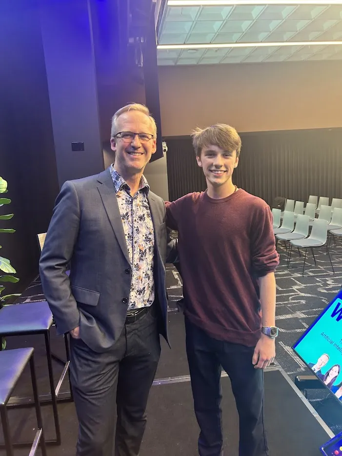 Gabriel stands with BC Minister Rick Glumac at The Age of Artificial Intelligence event.