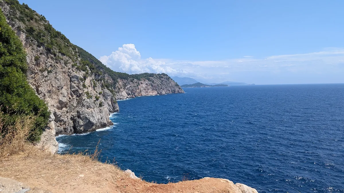 Rocky cliffs and blue sea line the coast during Gabriel’s island travels in Croatia.