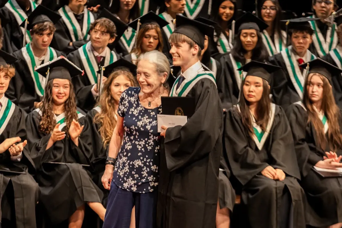 Gabriel stands with Linda Johnston after receiving his West End Community Centre awards at graduation.