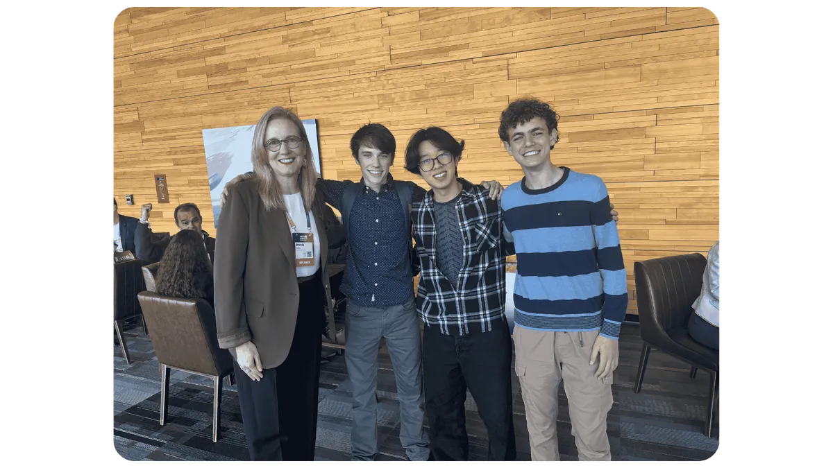 Gabriel, Darien Yang and Yousef Soliman stand with British Columbia Finance Minister Brenda Bailey at Web Summit.